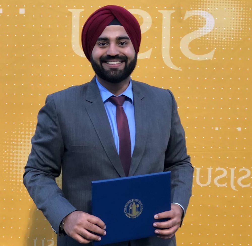 Ramneet Singh poses in front of a yellow 菠菜网lol正规平台 background.