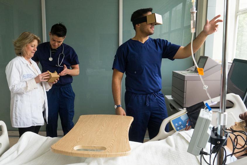 A nursing student practices with a VR headset.